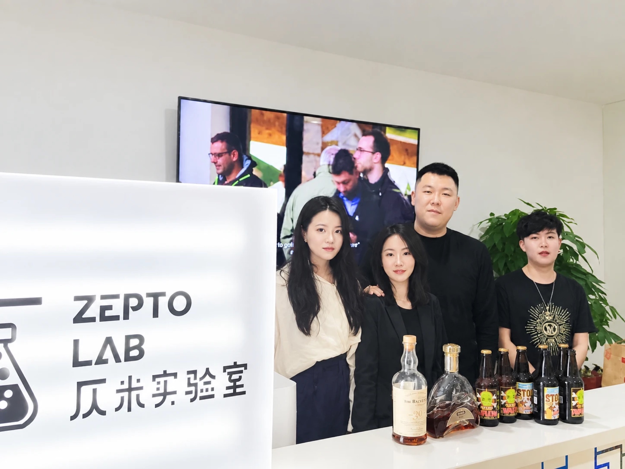 The Zepto Lab team at the studio, beside the Zepto Lab sign